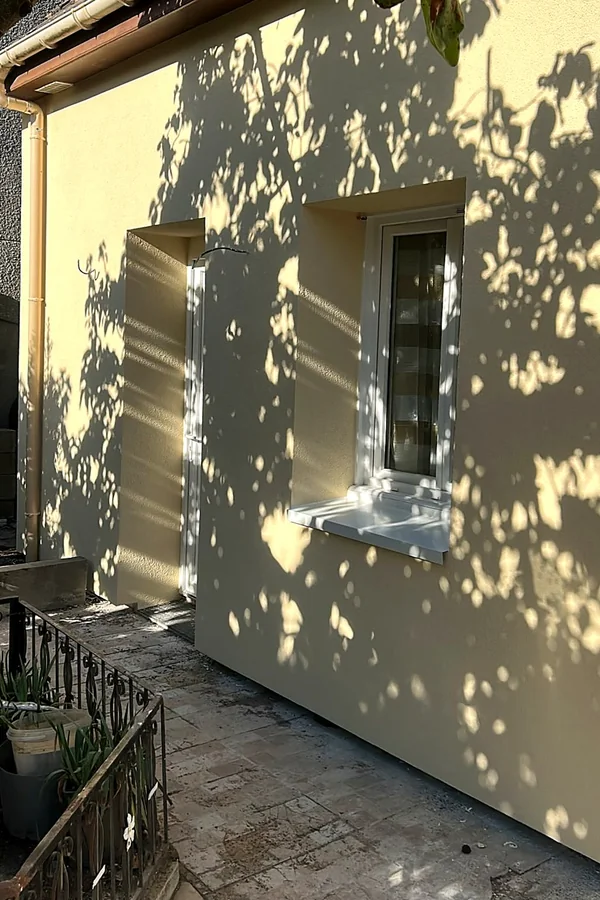 Façade d’accès rénovée après isolation thermique extérieure à Fleury-les-Aubrais