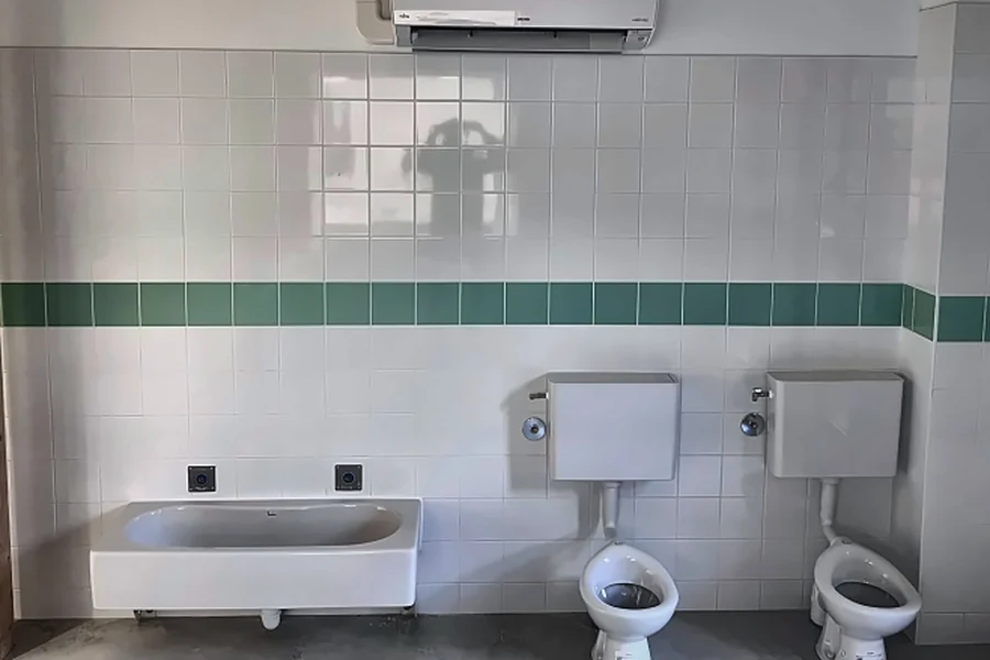 Lavabo adapté aux enfants, deux WC et unité murale de climatisation installés dans une école maternelle à Saint-Laurent-Nouan (41).